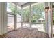 Screened porch with brick floor, ceiling fan, and view of the backyard at 1714 Middle St, Sullivans Island, SC 29482