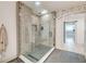 Modern bathroom with glass enclosed shower featuring gray tiling, hexagon flooring and an arched doorway at 1714 Middle St, Sullivans Island, SC 29482