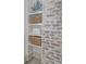 Bathroom shelving with woven baskets and neatly folded towels next to a brick accent wall at 1714 Middle St, Sullivans Island, SC 29482