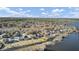 Expansive aerial view showcasing beautiful homes nestled near the water, enveloped by lush trees and clear blue skies at 1739 Indigo Island Dr, Hanahan, SC 29410
