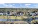 A stunning aerial view of beautiful homes along the waterfront, surrounded by lush trees and green lawns under a sunny sky at 1739 Indigo Island Dr, Hanahan, SC 29410