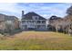 View of the backyard with a large grassy area leading up to the home with multiple decks at 1739 Indigo Island Dr, Hanahan, SC 29410