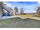 Spacious backyard featuring a large grassy lawn with a concrete patio and stairs leading up to a deck at 1739 Indigo Island Dr, Hanahan, SC 29410