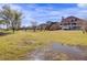 Backyards with a pond in the foreground with homes visible in the background on a sunny day at 1739 Indigo Island Dr, Hanahan, SC 29410