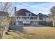 Stunning backyard view of the home with a large grassy area, multiple decks, and beautiful architectural design at 1739 Indigo Island Dr, Hanahan, SC 29410