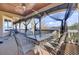 Relaxing covered deck with seating and a view of the lake, great for outdoor dining and entertaining at 1739 Indigo Island Dr, Hanahan, SC 29410