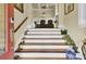 Elegant foyer with hardwood stairs and wood banister leading to a bright, open living space at 1739 Indigo Island Dr, Hanahan, SC 29410