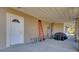 Covered area with white door, beige wall, ladders, and lawn equipment at 1739 Indigo Island Dr, Hanahan, SC 29410