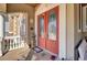 Charming front porch with red double doors, potted plants, and cozy seating at 1739 Indigo Island Dr, Hanahan, SC 29410