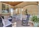 Inviting covered front porch with comfortable seating, rocking chairs, and elegant columns at 1739 Indigo Island Dr, Hanahan, SC 29410