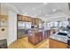 Open kitchen with large island, stainless steel refrigerator, and adjacent dining area at 1739 Indigo Island Dr, Hanahan, SC 29410