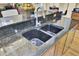 Kitchen featuring a deep double sink, dark granite countertop, and gooseneck faucet at 1739 Indigo Island Dr, Hanahan, SC 29410