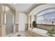 Luxurious main bathroom with soaking tub, walk-in shower, and arched window with privacy blinds at 1739 Indigo Island Dr, Hanahan, SC 29410