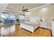 Bright main bedroom with tray ceiling, wood floors, sitting area, and walk-out to screened porch at 1739 Indigo Island Dr, Hanahan, SC 29410
