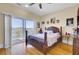 Main bedroom with hardwood floors and a sliding door leading to a deck with lake views at 1739 Indigo Island Dr, Hanahan, SC 29410