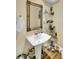 Charming powder room featuring pedestal sink, ornate mirror, and decorative accents at 1739 Indigo Island Dr, Hanahan, SC 29410