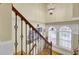 Elegant staircase featuring wood steps, decorative iron railings, and a stylish chandelier at 1739 Indigo Island Dr, Hanahan, SC 29410