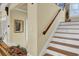 Classic staircase featuring wooden handrail and white steps, leading to the upper level at 1739 Indigo Island Dr, Hanahan, SC 29410