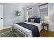 Sunlit bedroom features a metal bed frame, side tables with lamps, and calming light blue walls at 19 N Enston Ave, Charleston, SC 29403