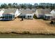 Aerial view showcases the home's backyard with a pond view and pergola-covered patio at 192 Sea Lavender Ln, Summerville, SC 29486