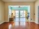 Inviting living room with wood floors leads to cozy sunroom with a ceiling fan and sliding glass doors at 192 Sea Lavender Ln, Summerville, SC 29486