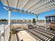 Charming patio with pergola overlooking a serene pond and neighborhood homes, offering an inviting outdoor space at 192 Sea Lavender Ln, Summerville, SC 29486