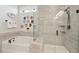 Elegant bathroom with a soaking tub, glass-enclosed shower, and neutral tile at 1930 Carolina Towne Ct, Mount Pleasant, SC 29464