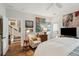 Sunlit bedroom with a ceiling fan, decorative art, and striped armchair at 1930 Carolina Towne Ct, Mount Pleasant, SC 29464