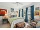 Charming bedroom with a decorative armchair, patterned bedding, and bright blue curtains at 1930 Carolina Towne Ct, Mount Pleasant, SC 29464