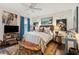Well-decorated bedroom with a ceiling fan, unique bench, and a large flat screen television at 1930 Carolina Towne Ct, Mount Pleasant, SC 29464