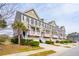 Street view of well-maintained townhomes with garages and inviting front porches at 1930 Carolina Towne Ct, Mount Pleasant, SC 29464