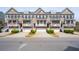 Attractive townhomes feature individual garages and covered front porches, creating inviting curb appeal at 1930 Carolina Towne Ct, Mount Pleasant, SC 29464