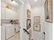 Well-lit laundry room with front load washer/dryer, utility sink, and extra cabinet space at 1930 Carolina Towne Ct, Mount Pleasant, SC 29464