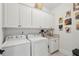 Functional laundry room featuring upper cabinets, a utility sink, and modern appliances at 1930 Carolina Towne Ct, Mount Pleasant, SC 29464