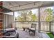 Cozy covered patio with stylish wicker furniture, rug, and string lights overlooking the pond at 1930 Carolina Towne Ct, Mount Pleasant, SC 29464
