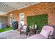Comfortable covered patio features wicker furniture, plants, and a privacy screen at 1930 Carolina Towne Ct, Mount Pleasant, SC 29464