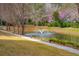 Beautiful pond with a fountain, surrounded by trees and a walking path at 1930 Carolina Towne Ct, Mount Pleasant, SC 29464