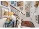 Elegant staircase with decorative art hanging on the walls and hardwood floors at 1930 Carolina Towne Ct, Mount Pleasant, SC 29464