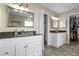 Bright bathroom featuring double vanities, granite countertops, and a spacious walk-in closet for ample storage at 1975 Trimbleston Pl, Mount Pleasant, SC 29464