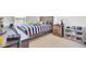 Cozy bedroom with wood furniture, carpet floors, and toy storage at 202 N Light Way, Summerville, SC 29486