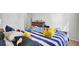 Bright bedroom with colorful stuffed animals on a striped comforter at 202 N Light Way, Summerville, SC 29486