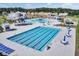 Aerial view of a large community pool with lap lanes, a water slide, seating, and a separate shallow area at 202 N Light Way, Summerville, SC 29486