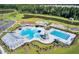 An aerial view of the community pool area with multiple pools, slides, splashpad, and lake at 202 N Light Way, Summerville, SC 29486