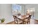 Bright dining area features a wood table, four chairs, wood floor, and sliding glass doors to the backyard at 202 N Light Way, Summerville, SC 29486