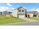 Traditional home exterior showcases a well-kept lawn and two-car garage, perfect for suburban living at 202 N Light Way, Summerville, SC 29486