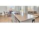 Open kitchen view with granite countertops, stainless steel appliances, central island, and dining area at 202 N Light Way, Summerville, SC 29486