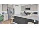 Modern kitchen features granite countertops, stainless steel appliances, and an island with barstool seating at 202 N Light Way, Summerville, SC 29486