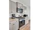 Kitchen features stainless steel appliances, granite countertops, and light grey cabinetry at 202 N Light Way, Summerville, SC 29486