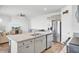 Modern kitchen with granite countertops, island, stainless steel appliances, and access to living room at 202 N Light Way, Summerville, SC 29486
