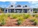 A great view of the pool pavilion with a metal roof and dormer windows overlooking lush landscaping at 202 N Light Way, Summerville, SC 29486